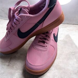 Nike Women's Pink Low-Top Sneakers with Black Swoosh and Gum Sole